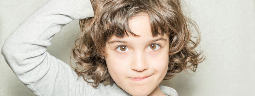 Girl itching her head because she has lice