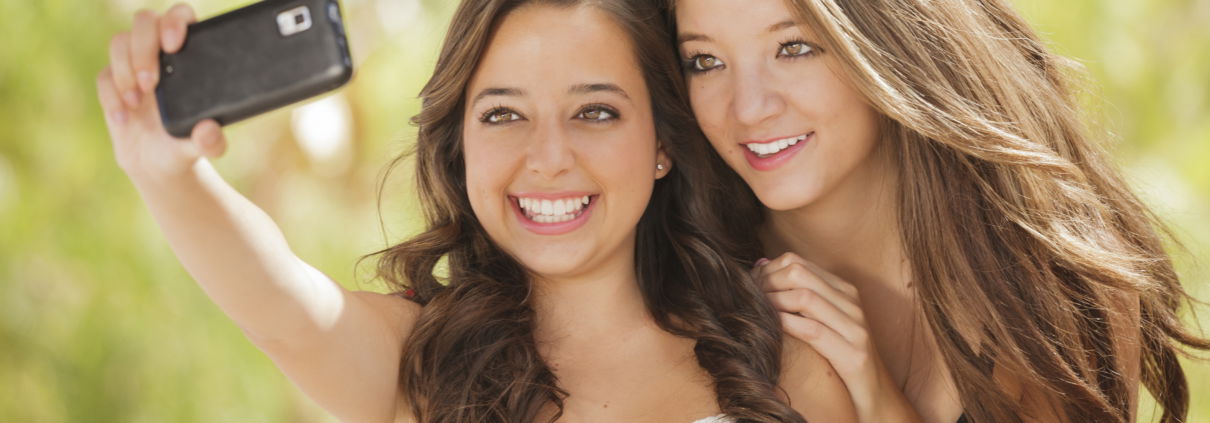 Two girls taking a selfie and smiling